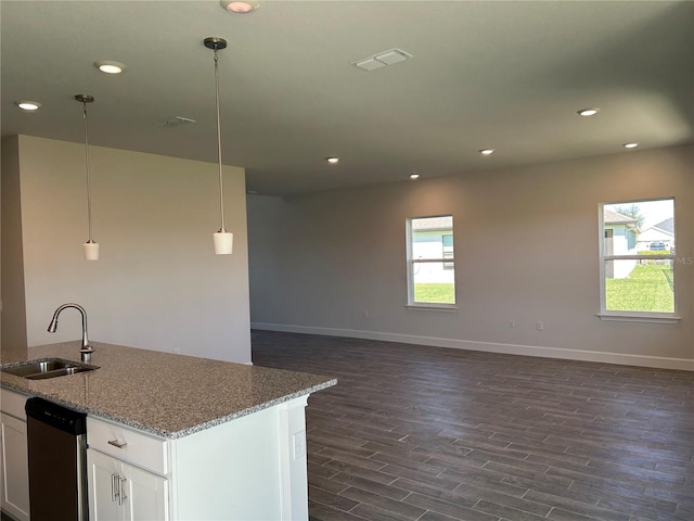 kitchen featuring white cabinetry, sink, dark wood-type flooring, stainless steel dishwasher, and pendant lighting