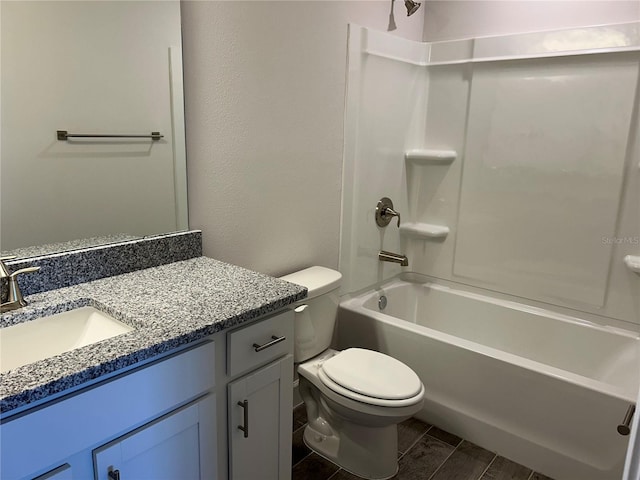 full bathroom featuring hardwood / wood-style flooring, vanity, toilet, and washtub / shower combination