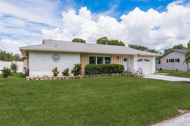 single story home featuring a garage and a front yard