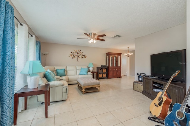 tiled living room with a textured ceiling and ceiling fan with notable chandelier