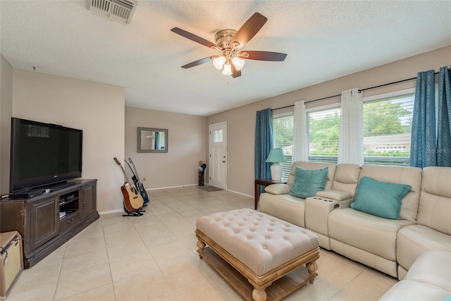 tiled living room featuring a textured ceiling and ceiling fan