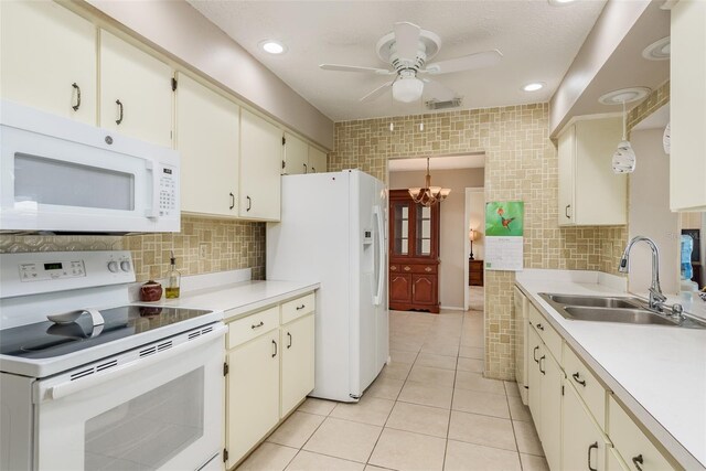 kitchen featuring light tile patterned flooring, white appliances, tasteful backsplash, and sink