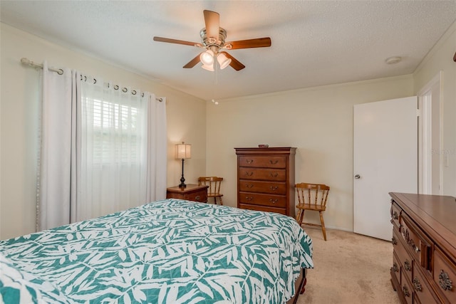 carpeted bedroom with ceiling fan and a textured ceiling