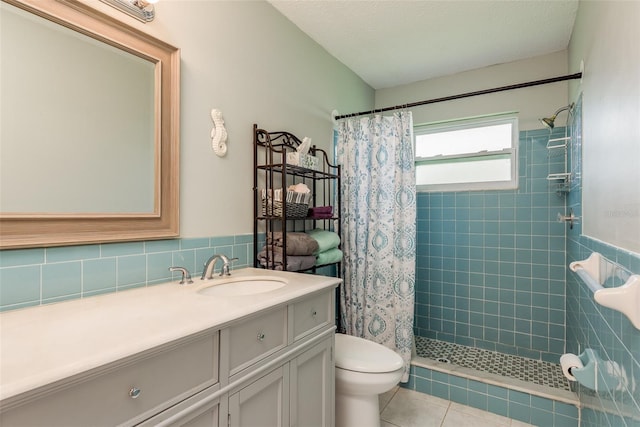 bathroom with toilet, tile patterned flooring, vanity, and walk in shower