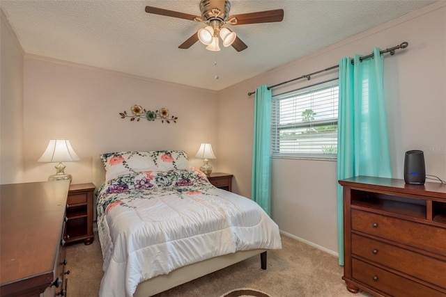 bedroom with a textured ceiling, light colored carpet, and ceiling fan