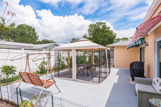 view of patio / terrace featuring a gazebo and a grill