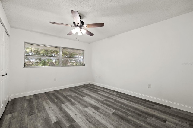 empty room featuring a textured ceiling, ceiling fan, and dark wood-type flooring