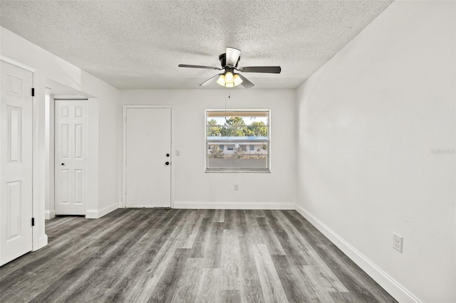 unfurnished room with ceiling fan, wood-type flooring, and a textured ceiling