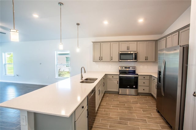 25434 Colon Dr, Punta Gorda, FL 33983 - kitchen featuring appliances with stainless steel finishes, gray cabinetry, a sink, a peninsula, and lofted ceiling