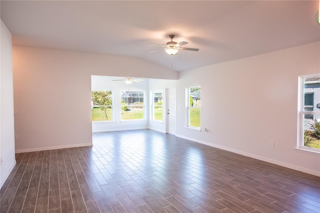 empty room featuring ceiling fan, dark wood-type flooring, a healthy amount of sunlight, and vaulted ceiling