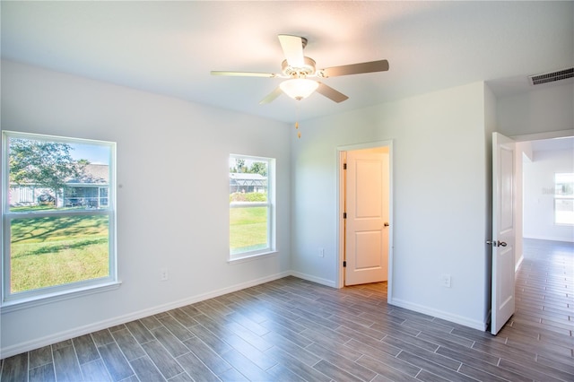 unfurnished bedroom featuring ceiling fan and dark hardwood / wood-style floors