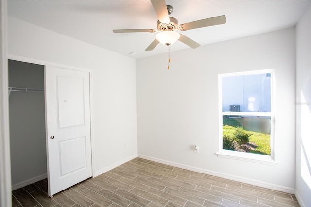 unfurnished bedroom featuring ceiling fan and a closet