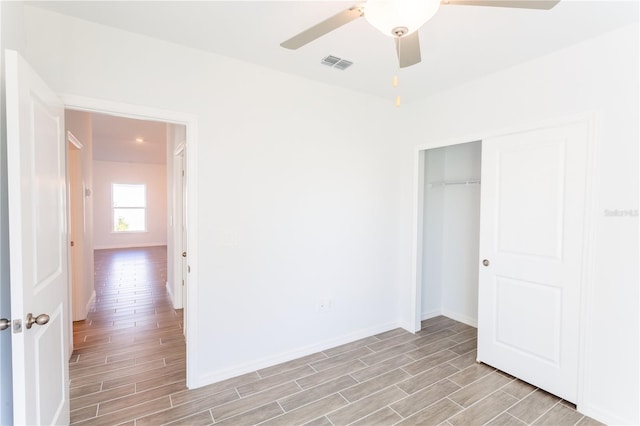 unfurnished bedroom with ceiling fan, a closet, and light hardwood / wood-style flooring