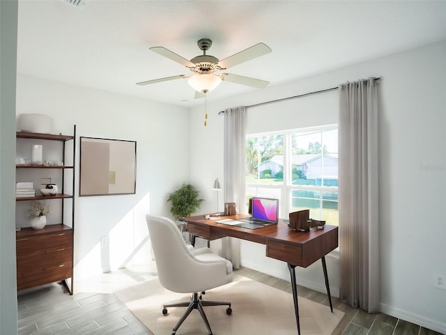 office space featuring light wood-type flooring and ceiling fan