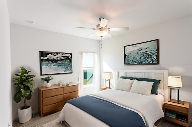 bedroom with ceiling fan and light wood-type flooring