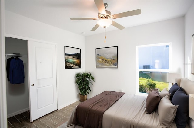 bedroom with a closet, ceiling fan, and dark hardwood / wood-style flooring