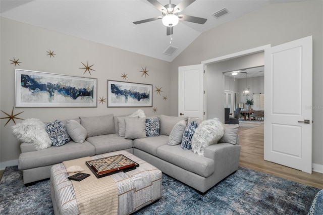 living room featuring hardwood / wood-style floors, ceiling fan, and lofted ceiling