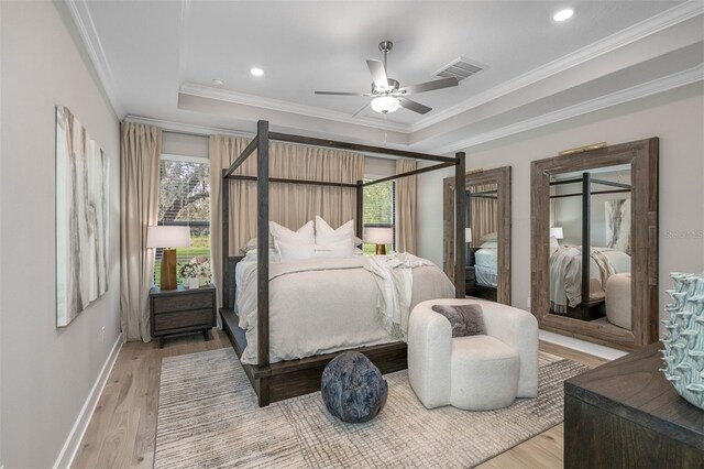 bedroom with multiple windows, ceiling fan, hardwood / wood-style floors, and ornamental molding