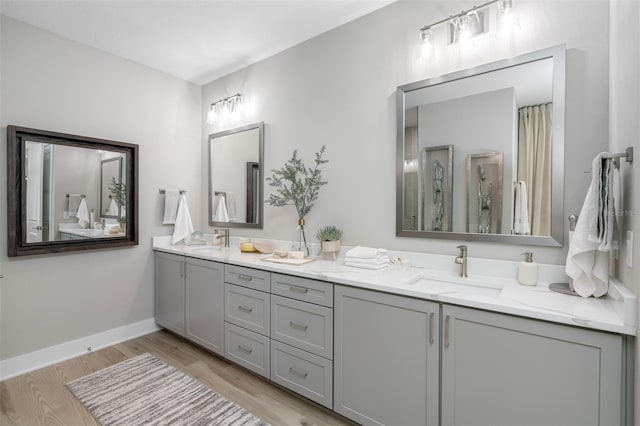 bathroom with a shower, vanity, and hardwood / wood-style flooring