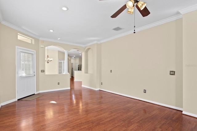 interior space with hardwood / wood-style floors, ceiling fan with notable chandelier, and crown molding