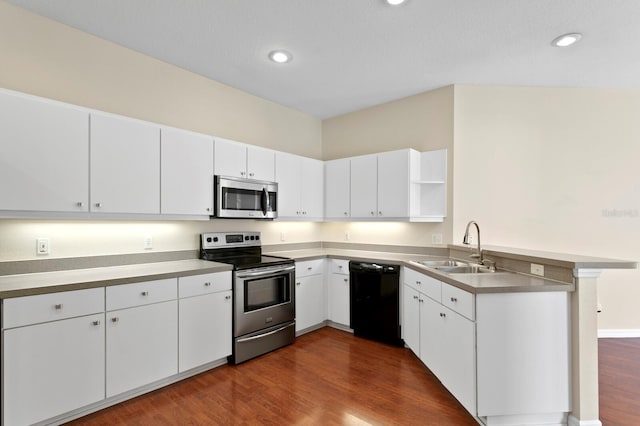 kitchen with stainless steel appliances, white cabinetry, dark hardwood / wood-style floors, and sink