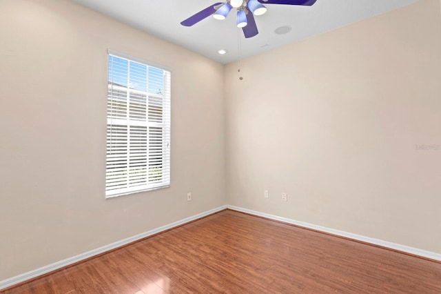 empty room with hardwood / wood-style flooring and ceiling fan