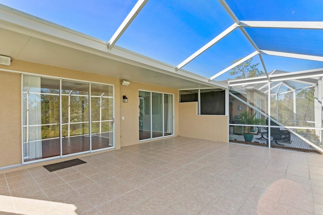 view of patio featuring a lanai