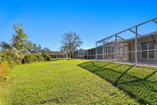 view of yard with glass enclosure