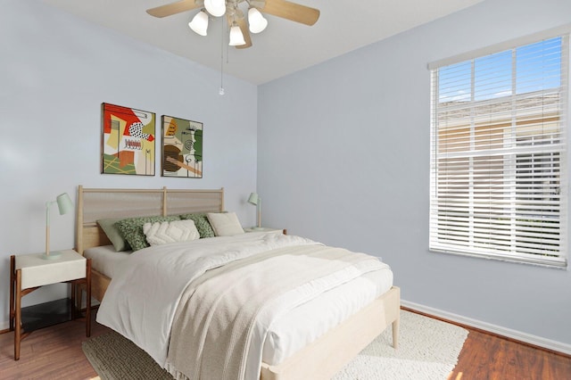 bedroom with ceiling fan and hardwood / wood-style floors