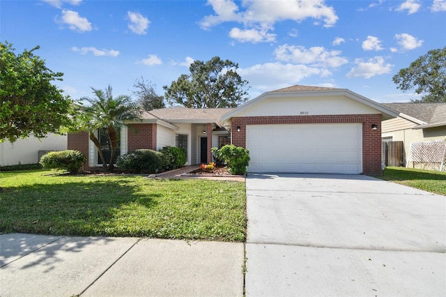 single story home with a garage and a front lawn