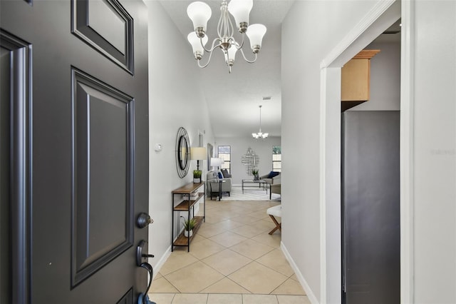 foyer entrance featuring a notable chandelier and light tile patterned flooring