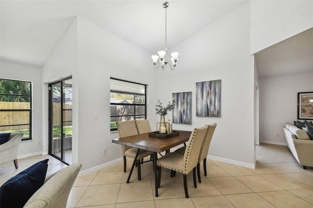 dining area featuring high vaulted ceiling, a notable chandelier, and light tile patterned flooring