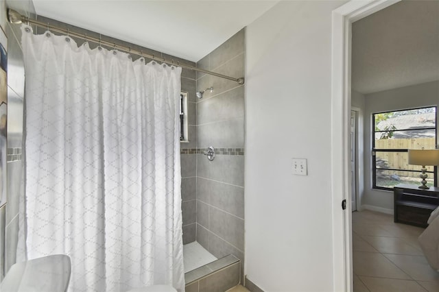 bathroom with tile patterned floors and a shower with shower curtain