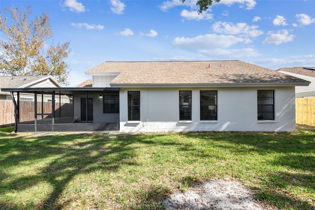 back of property featuring a yard and a sunroom