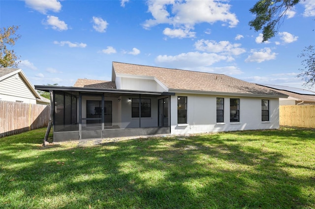 back of property featuring a lawn and a sunroom