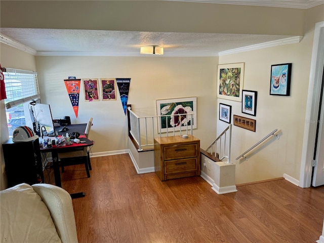 office area with wood-type flooring and ornamental molding