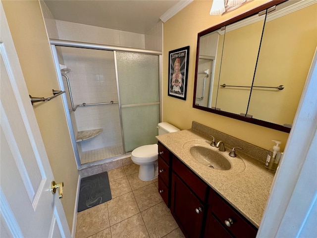 bathroom featuring vanity, a shower with door, crown molding, tile patterned flooring, and toilet