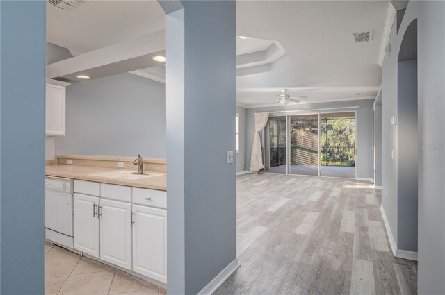 kitchen featuring white cabinetry, dishwasher, light hardwood / wood-style floors, and sink