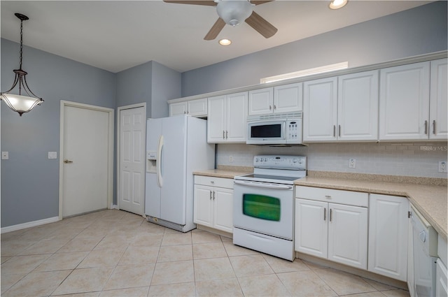 kitchen with white appliances, backsplash, white cabinets, light tile patterned floors, and decorative light fixtures