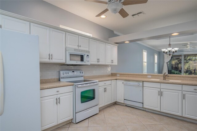 kitchen featuring white cabinets, decorative backsplash, white appliances, and sink