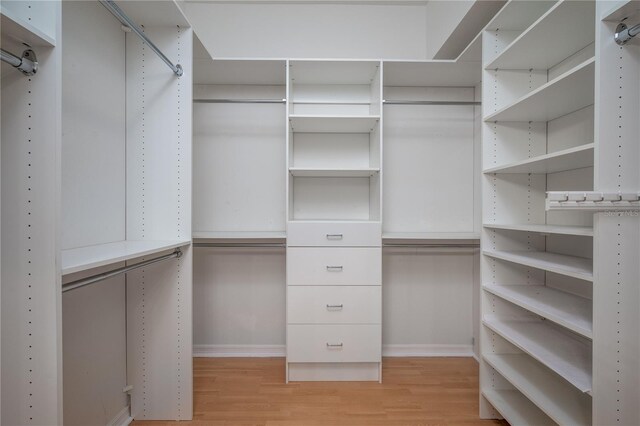 spacious closet with light hardwood / wood-style floors