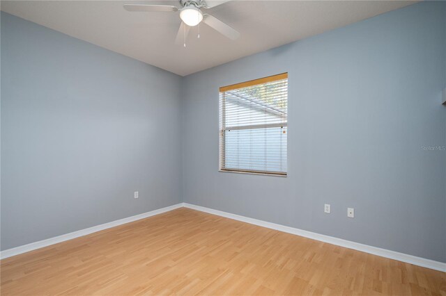 empty room with ceiling fan and light wood-type flooring