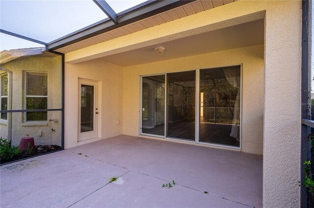 view of patio with glass enclosure