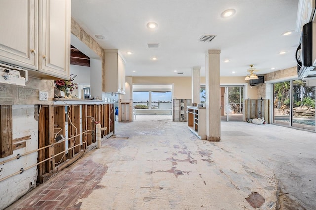 interior space featuring decorative columns and a wealth of natural light