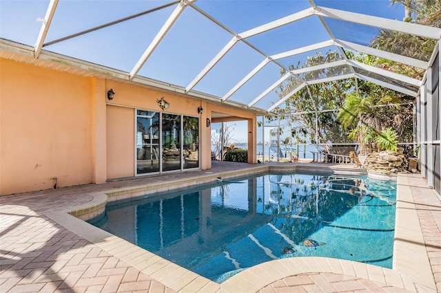 view of swimming pool with a lanai and a patio area