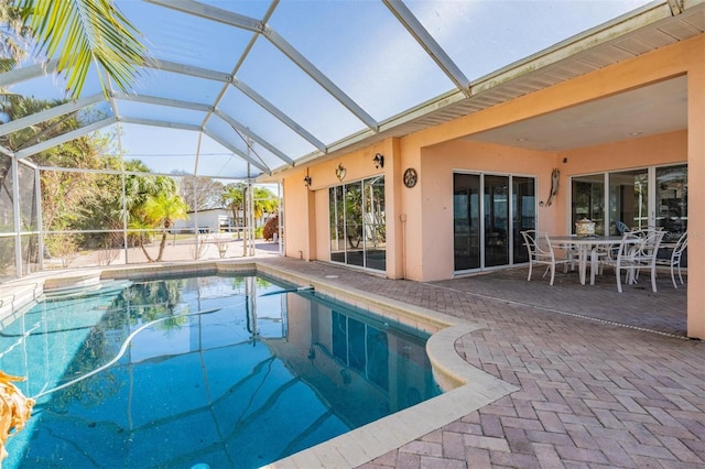 view of swimming pool featuring a patio and glass enclosure