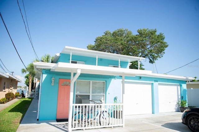 view of front facade with a porch and a garage