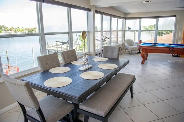 sunroom featuring plenty of natural light, a water view, and pool table