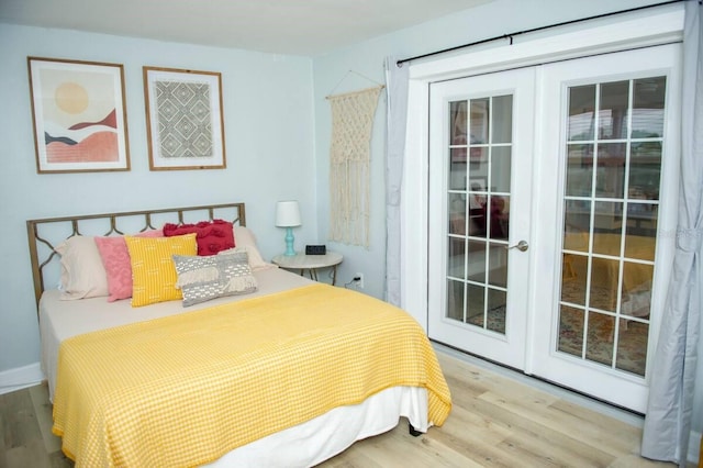 bedroom with light hardwood / wood-style floors, access to exterior, and french doors