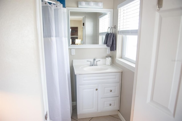 bathroom featuring tile patterned floors, vanity, and walk in shower